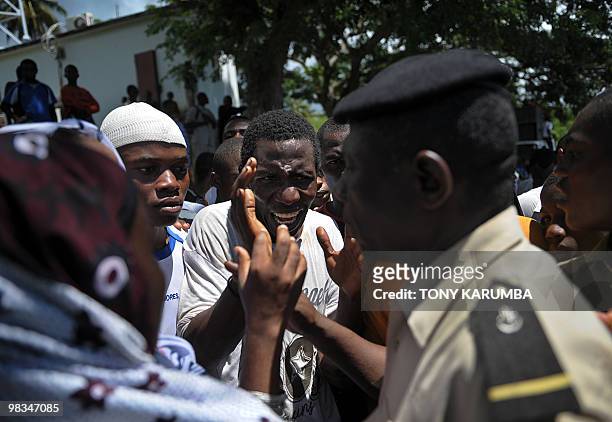 Police officer attempts to calm protestors marching a street of Moheli [Mwali] April 09, 2010 to demonstrate against President Ahmed Abdalla Sambi's...