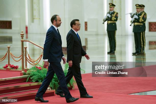 Chinese Premier Li Keqiang invites French Prime Minister Edouard Philippe to view an honour guard during a welcoming ceremony inside the Great Hall...