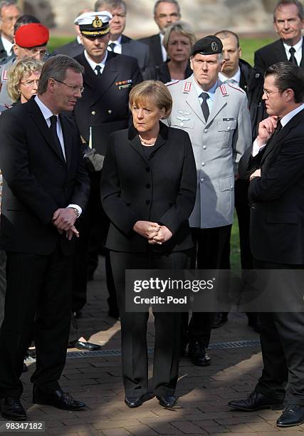 Lower Saxony Governor Christian Wulff, German Chancellor Angela Merkel and Defence Minister Karl-Theodor zu Guttenberg lead the funeral procession...