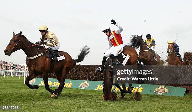 Jason Maguire takes a fall ridding Khachaturian in The matalan.co.uk Mildmay Novices' Steeple Chase at Aintree racecourse on April 9, 2010 in...