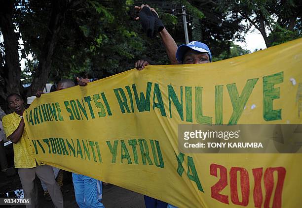 Protestors unfurled a large banner as they march in a street of Moheli on April 09, 2010 to demonstrate against President Ahmed Abdalla Sambi's...
