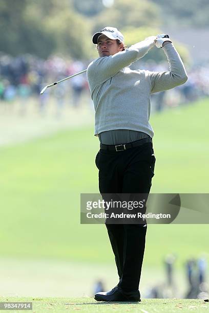 Adam Scott of Australia hits his approach shot on the first hole during the second round of the 2010 Masters Tournament at Augusta National Golf Club...