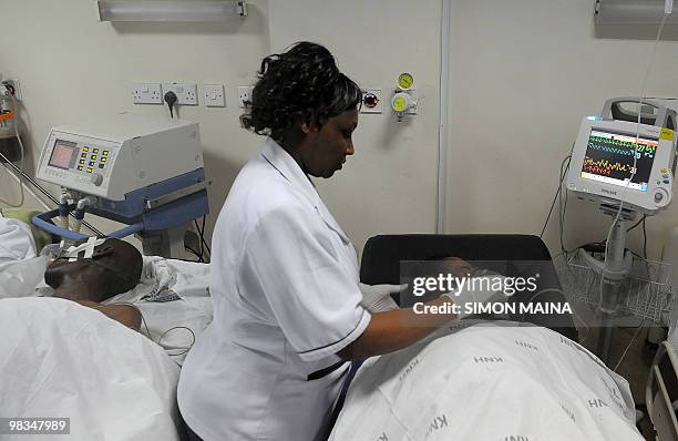 Nurse at the Kenyatta National hospital treats a victim after on April 9,2010 drinking illicit brew in Nairobi. At least seven people died Friday and...