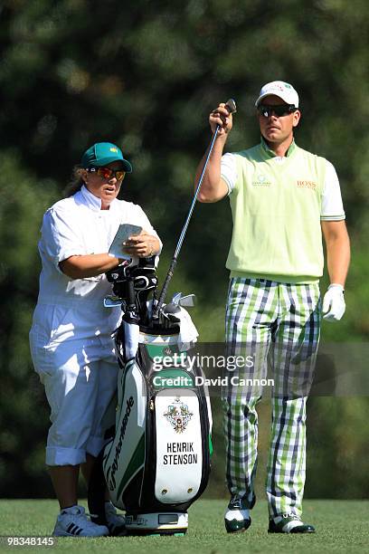 Henrik Stenson of Sweden waits with his caddie Fanny Sunesson on the fifth hole during the second round of the 2010 Masters Tournament at Augusta...