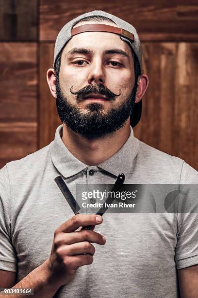 portrait of bearded hipster with straight edge razor - straight razor stock pictures, royalty-free photos & images