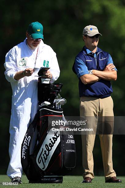 Zach Johnson waits with his caddie Damon Green on the fifth hole during the second round of the 2010 Masters Tournament at Augusta National Golf Club...