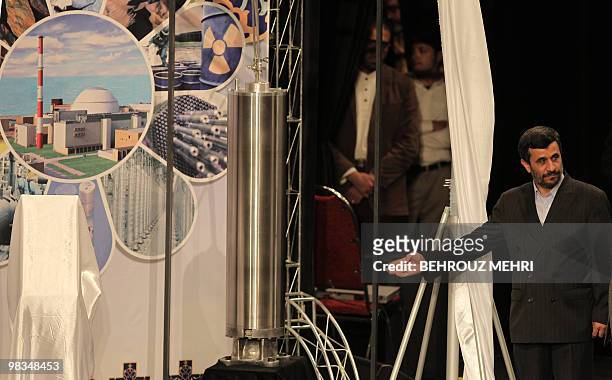 Iranian President Mahmoud Ahmadinejad unveils a sample of the third generation centrifuge for uranium enrichment during a ceremony to mark the...