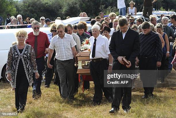 Relatives carry the coffin of slain white supremacist leader Eugene Terre'Blanche to his grave on his farm on April 9, 2010 in Ventersdorp. Flags of...