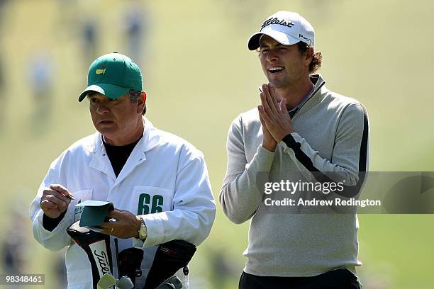 Adam Scott of Australia looks on from the first hole with his caddie Tony Navarro during the second round of the 2010 Masters Tournament at Augusta...