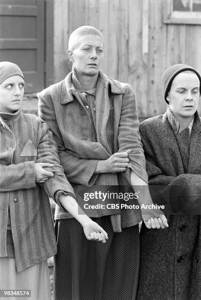 American actress Anna Levine and Faith Catlin flank British actress Vanessa Redgrave as they all present their foreamrs for inspection in a scene...