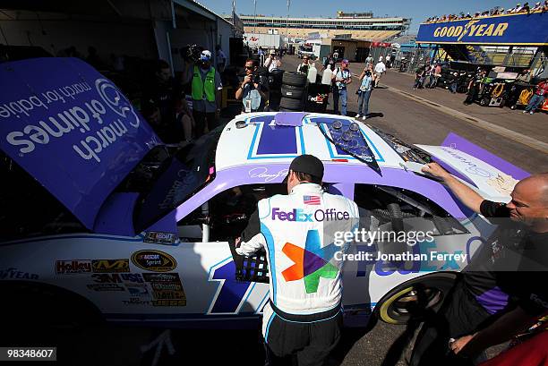 Denny Hamlin, driver of the FedEx Office/March of DimesToyota, climbs into his car during practice for the NASCAR Sprint Cup Series Subway Fresh Fit...