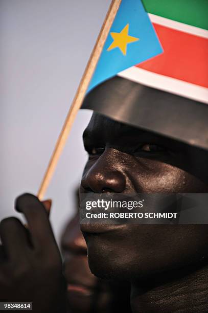 Supporter of Sudanese Vice President Salva Kiir, the current south Sudan leader and head of the SPLM, waves a southern flag as he listens to Kiir...