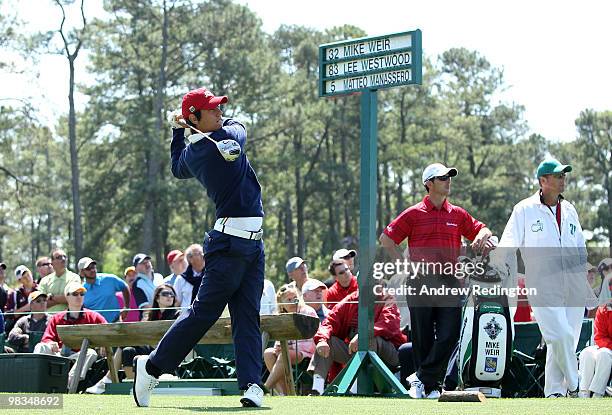 Amateur Matteo Manassero of Italy hits his tee shot on the first hole as Mike Weir of Canada looks on during the second round of the 2010 Masters...