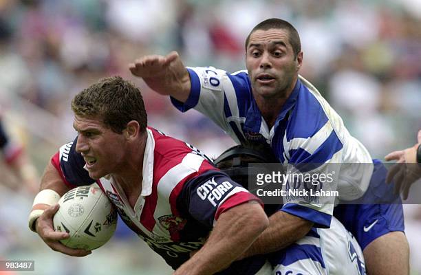Bryan Fletcher of the Sydney Roosters evades the tackle of Craig Polla-Mounter of the Bulldogs during the round 6 game of the National Rugby League...