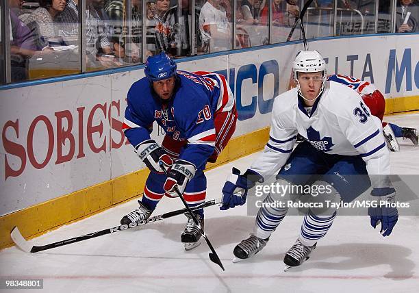 Vinny Prospal of the New York Rangers skates for the puck against Carl Gunnarsson of the Toronto Maple Leafs on April 7, 2010 at Madison Square...