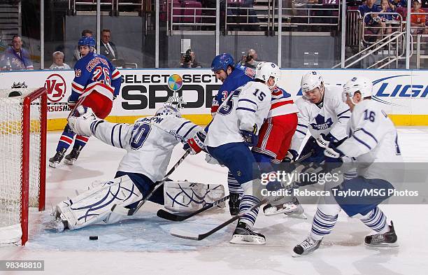 Goaltender Jonas Gustavsson of the Toronto Maple Leafs protects the net against Aaron Voros of the New York Rangers in the first period on April 7,...