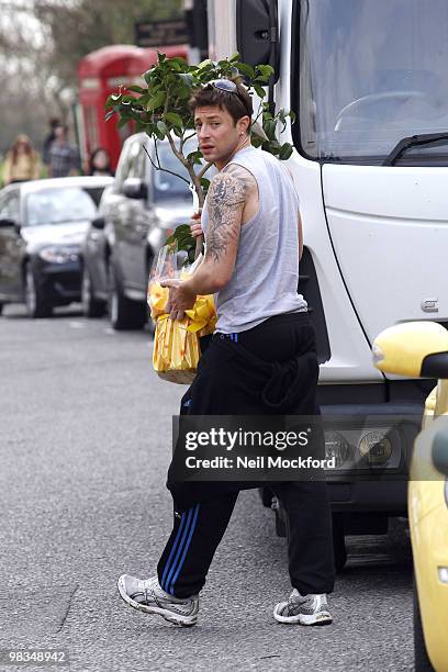 Duncan James loads a Lemon tree into his car, which was a birthday present from his mum, in Primrose Hill on April 9, 2010 in London, England.