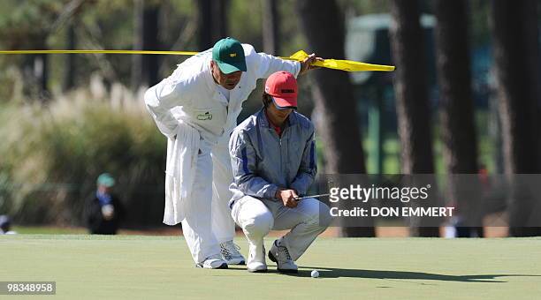 Han Chang-won of Korea lines a putt on the 3rd hole during the 2nd round of the Masters golf tournament at Augusta National Golf Club on April 9,...