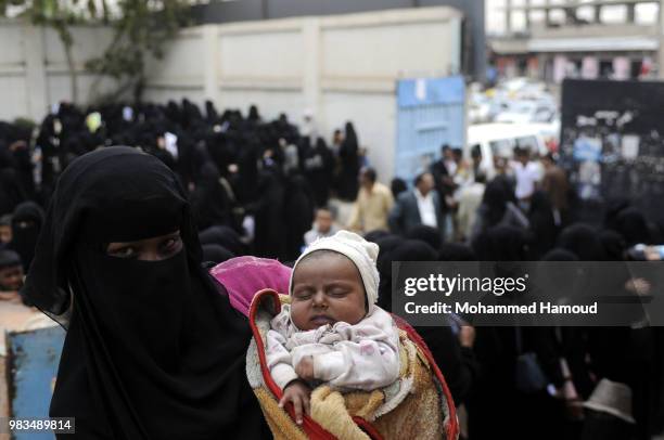 Displaced women who fled the war in Yemen’s port city of Hodeida wait to register at a displacement center on 23, 2018 in Sana’a, Yemen.