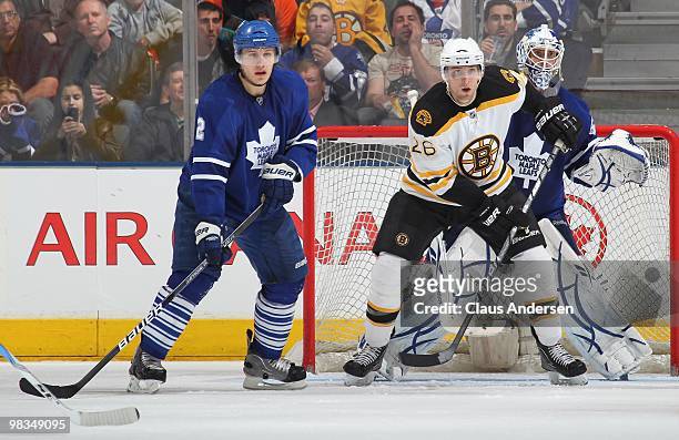 Blake Wheeler of the Boston Bruins waits to tip a shot between Luke Schenn and Jonas Gustavsson of the Toronto Maple Leafs in a game on April 3, 2010...