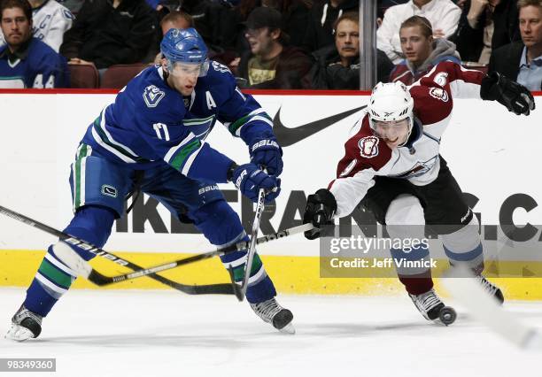 Ryan Kesler of the Vancouver Canucks and Matt Duchene of the Colorado Avalanche battle for the puck during the game at General Motors Place on April...