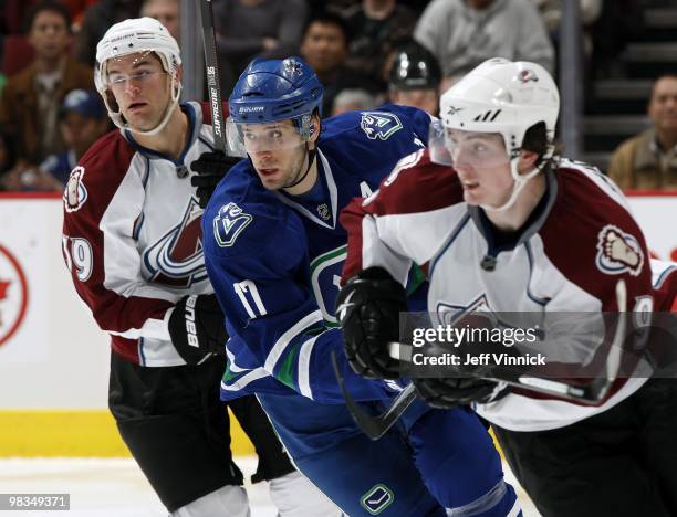 Ryan Kesler of the Vancouver Canucks and Matt Duchene and TJ Galiardi of the Colorado Avalanche skate up ice during the game at General Motors Place...