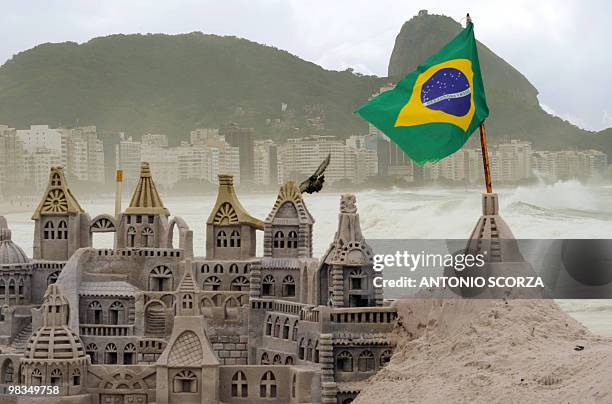 Picture of a sand sculpture made at Rio de Janeiro's Copacabana beach on April 9, 2010. The unusual roughness seen these days in Rio's Guanabara Bay...