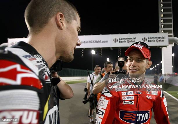 Ducati MotoGP rider Casey Stoner speaks with Ben Spies of Monster Yamaha Tech 3 following a group picture at Losail International Circuit in Doha,...
