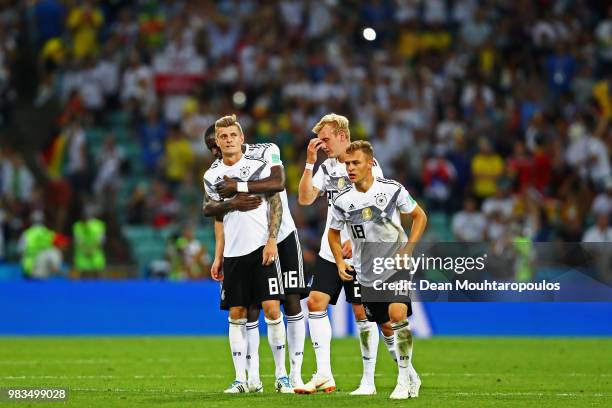 Toni Kroos of Germany is congratulated by team mates Antonio Rudiger, Julian Brandt and Joshua Kimmich after his winning goal in the final seconds of...