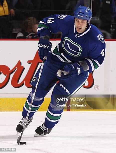 Andrew Alberts of the Vancouver Canucks skates up ice with the puck during the game against the Colorado Avalanche at General Motors Place on April...