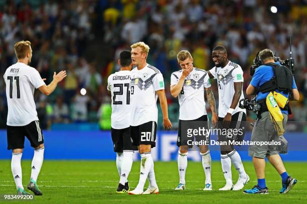 Toni Kroos of Germany is congratulated by team mates Antonio Rudiger, Julian Brandt, Ilkay Gundogan and Marco Reus after his winning goal in the...