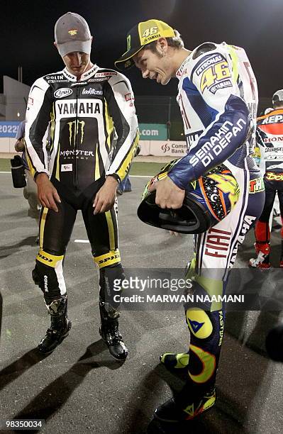 World champion Valentino Rossi of Italy speaks to Monster Yamaha Tech 3 driver Colin Edwards at Losail International Circuit in Qatar on April 9,...
