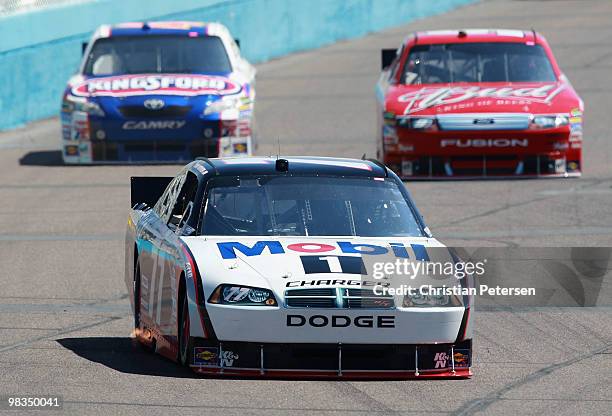 Sam Hornish Jr., driver of the Mobil 1 Dodge, drives ahead of Marcos Ambrose, driver of the Kingsford/Bush's Baked Beans Toyota, and Kasey Kahne,...