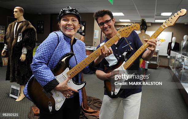 Maria Elena Holly , widow of rock legend Buddy Holly, poses with Holly impersonator John Mueller before an auction of the late singer's memorabilia...