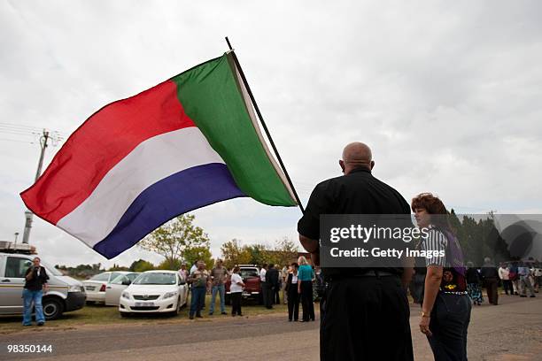 An AWB member waves the pre apartheid flag during the funeral of Afrikaner Resistance Movement slain leader Eugene Terre'Blanche on April 9, 2010 in...