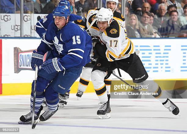 Milan Lucic of the Boston Bruins chases after Tomas Kaberle of the Toronto Maple Leafs in a game on April 3, 2010 at the Air Canada Centre in...
