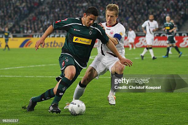 Christoph Spycher of Frankfurt challenges Rául Marcelo Bobadilla of Gladbach during the Bundesliga match between Borussia Moenchengladbach and...
