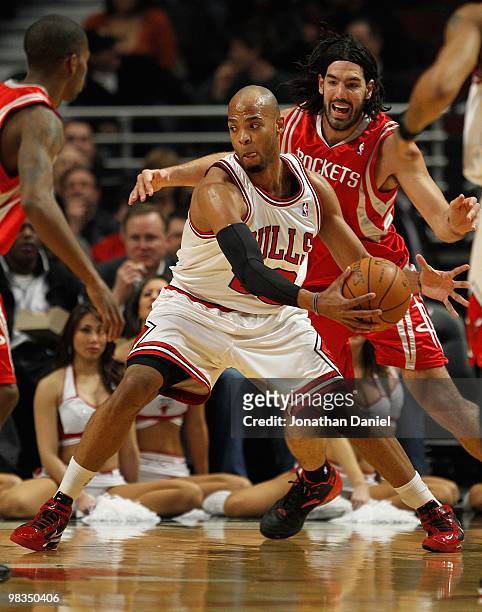 Taj Gibson of the Chicago Bulls moves past Luis Scola of the Houston Rockets at the United Center on March 22, 2010 in Chicago, Illinois. The Bulls...