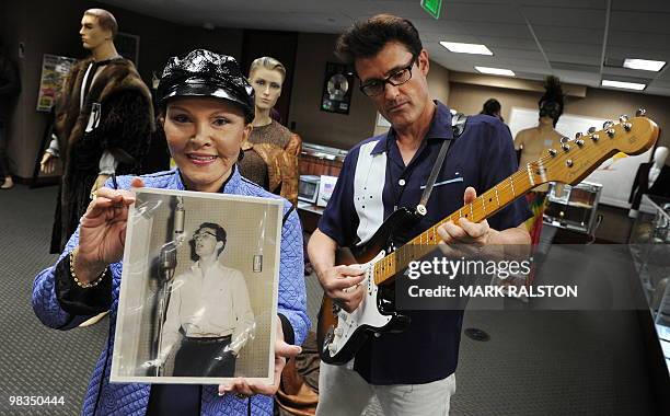Maria Elena Holly who is the widow of rock legend Buddy Holly, holds a rare studio photo of him beside Holly impersonator John Mueller before an...