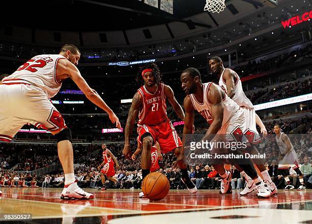Brad Miller and Ronald Murray of the Chicago Bulls and Jordan Hill of the Houston Rockets move toward a loose ball at the United Center on March 22,...