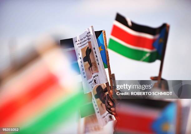Supporters of current south Sudan leader and head of the SPLM, Sudanese Vice President Salva Kiir, wave southern Sudanese flags and Kiir's portraits...