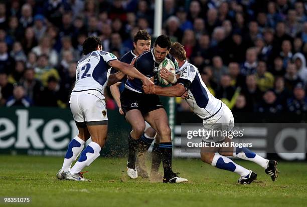 Rob Kearney of Leinster is tackled by Gonzalo Canale and Marius Joubert during the Heinken Cup quarter final match between Leinster and Clermont...