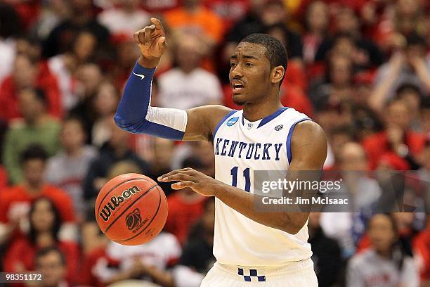 John Wall of the Kentucky Wildcats gestures as he brings the ball up court against the Cornell Big Red during the east regional semifinal of the 2010...