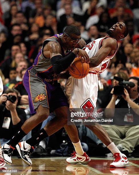 Amar'e Stoudemire of the Phoenix Suns runs into Hakim Warrick of the Chicago Bulls at the United Center on March 30, 2010 in Chicago, Illinois. The...