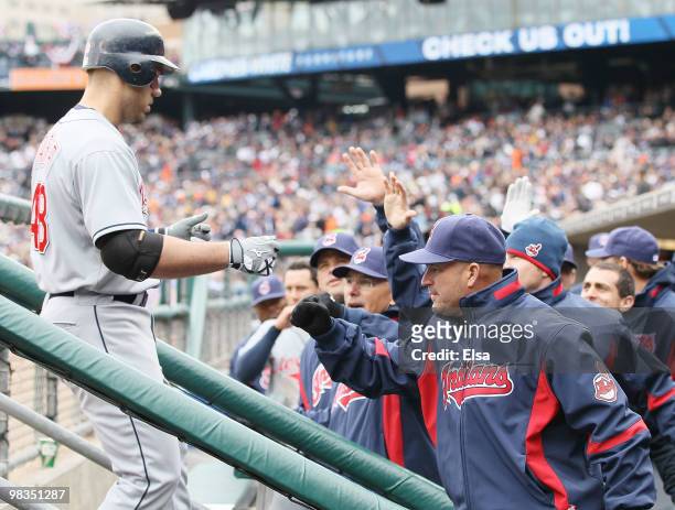 Travis Hafner of the Cleveland Indians is congratulated by manager Manny Acta and the rest of his team after his solo home run in the second inning...