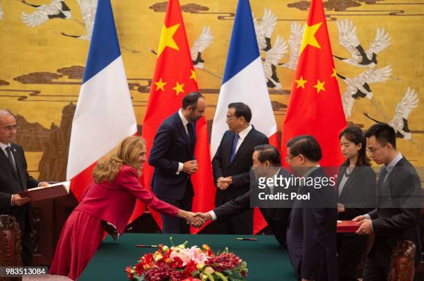 French Prime Minister Edouard Philippe speaks to China's Premier Li Keqiang as French Justice Minister Nicole Belloubet shakes hands with an...