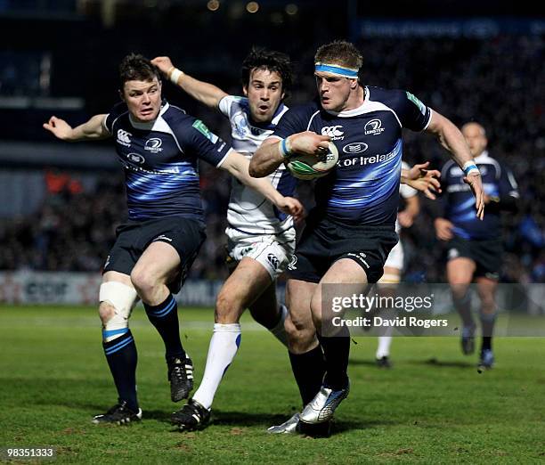 Jamie Heaslip, the Leinster number 8 races away to score a try despite being held by Morgan Parra , looking on is Brian O'Driscoll during the Heinken...