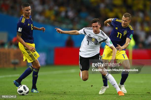 Julian Draxler of Germany battles for the ball with Mikael Lustig and Viktor Claesson of Sweden during the 2018 FIFA World Cup Russia group F match...