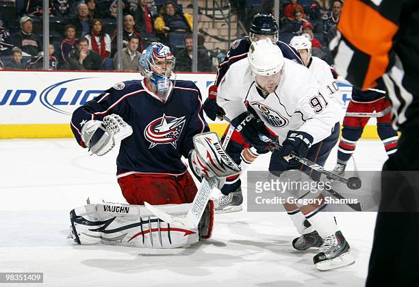 Goaltender Steve Mason of the Columbus Blue Jackets defends his net against Mike Comrie of the Edmonton Oilers during their NHL game on March 15,...