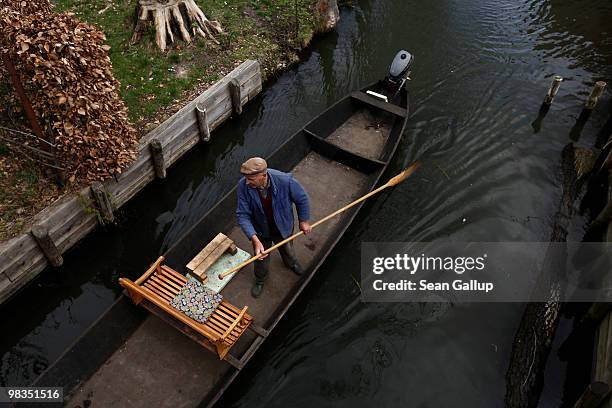 Local resident in a pirogue navigates the narrow canals of the Spreewald forest on April 9, 2010 in Luebbenau, Germany. The Spreewald is interlaced...